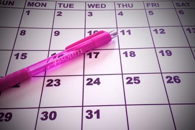 Calendar with dates and a pink pen on it
